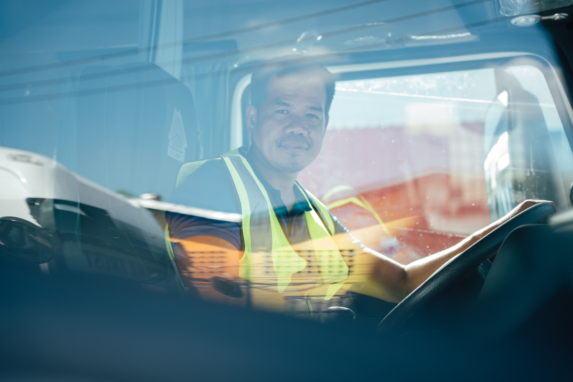 Westwind Logistics driver inside a truck cab, representing real-time GPS tracking and efficiency in logistics operations.